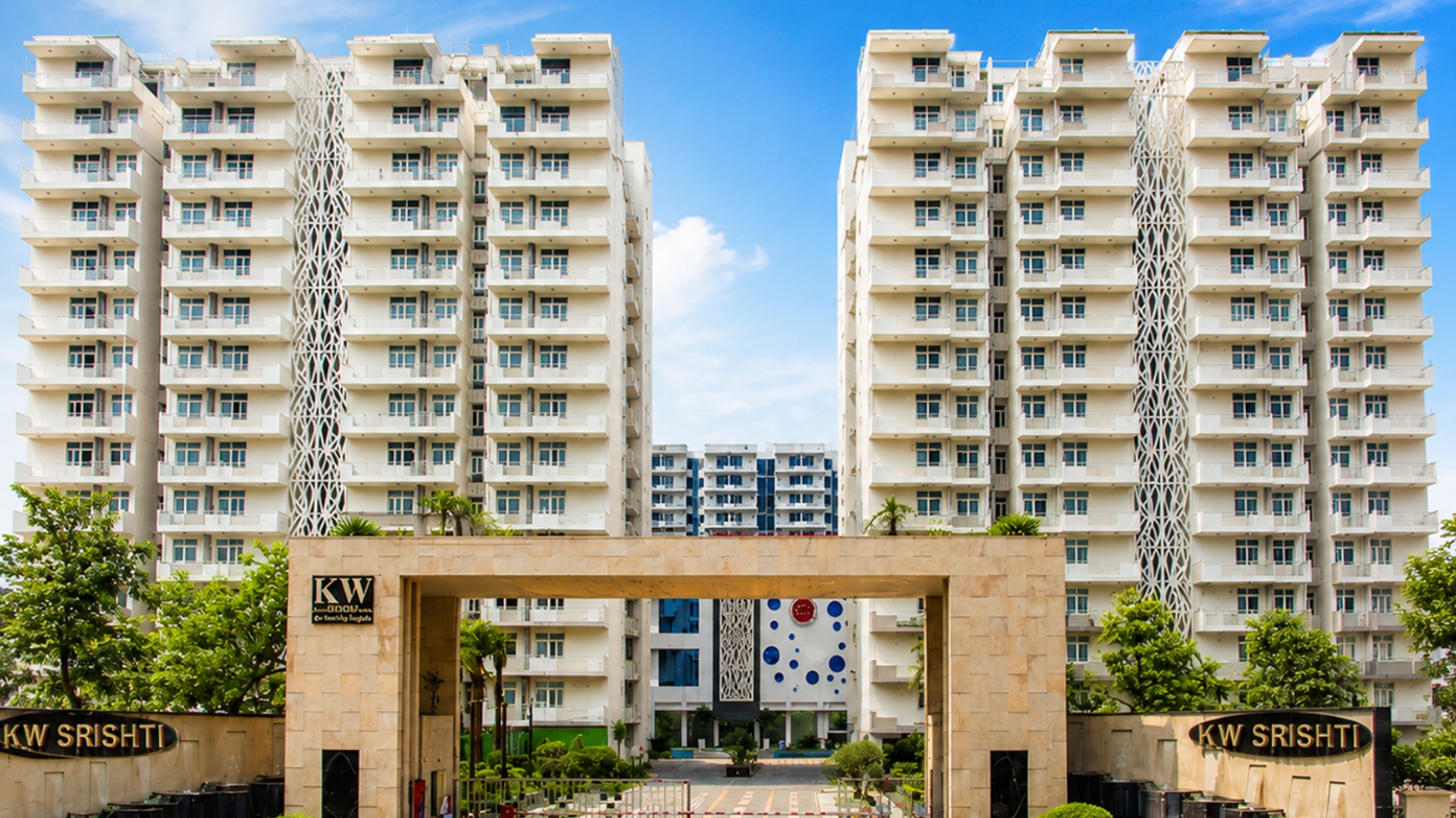 KW Srishti — twin-tower gateway facade at the 10-acre Raj Nagar Extension township