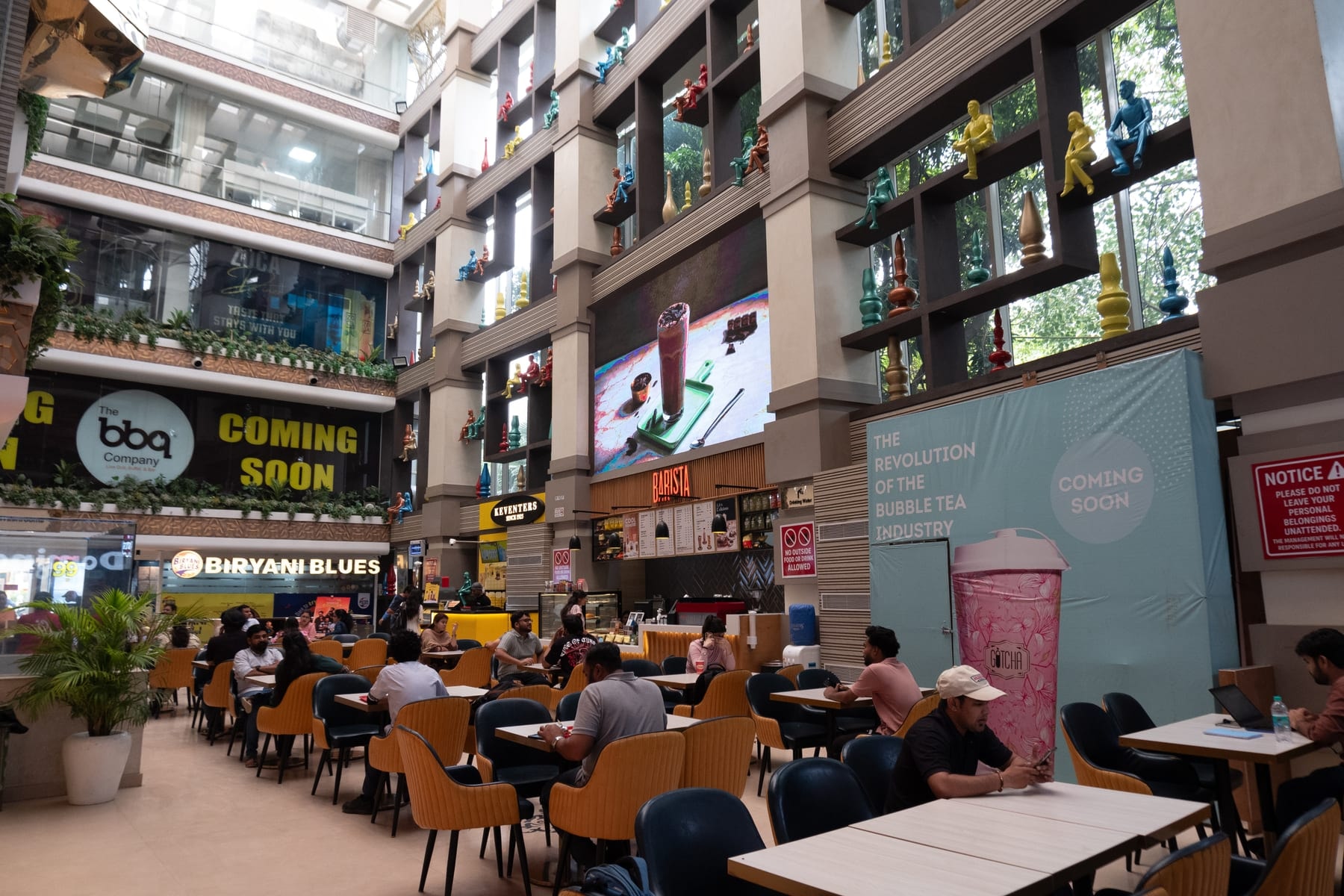 KW Blue Pearl food-court dining amid brand storefronts