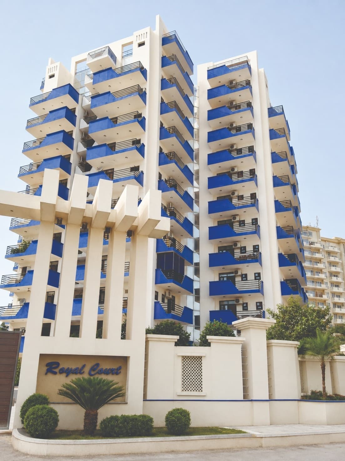 Royal Court tower with signature blue balconies and white colonnade in Sector 39, Gurugram